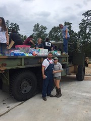   Tamara Perry and her husband Michael use their deuce and half to help transport food, supplies, and water into areas t...