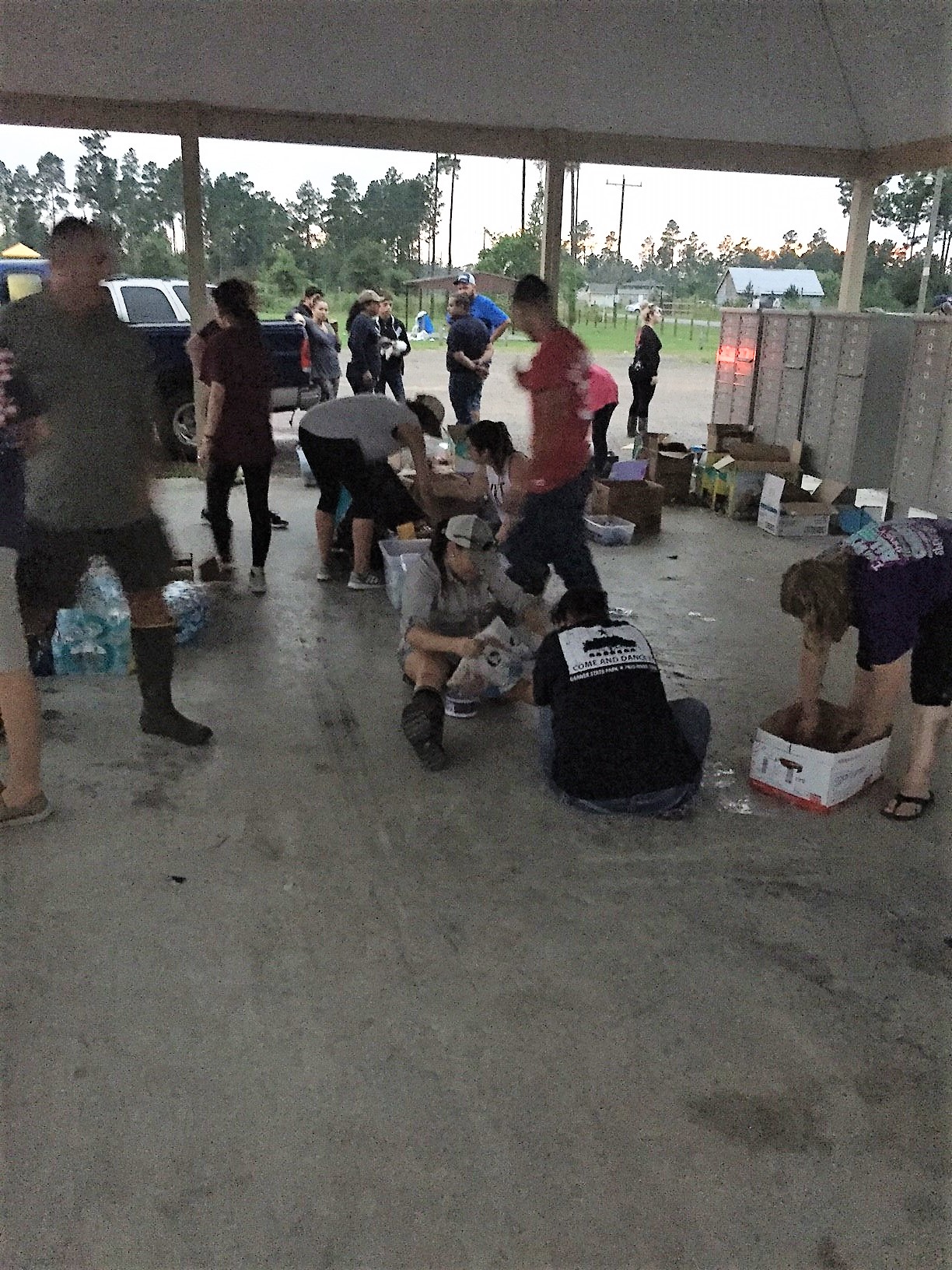  Once through the flood waters, volunteers begin distributing supplies.